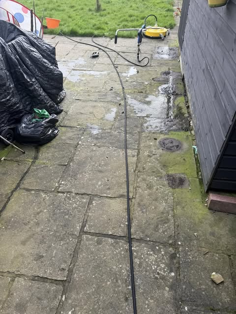 Garden patio with pressure washing hose and equipment