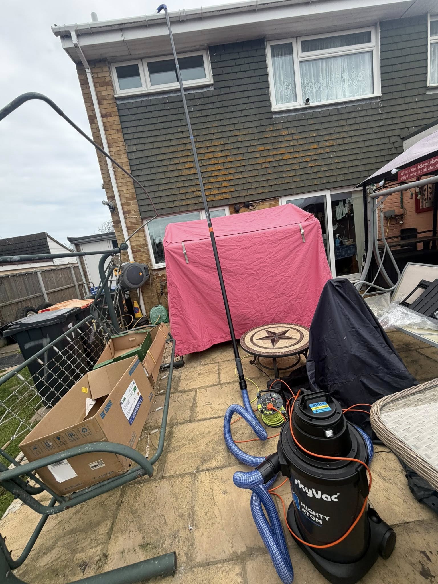 Outdoor patio with cleaning equipment and covered furniture