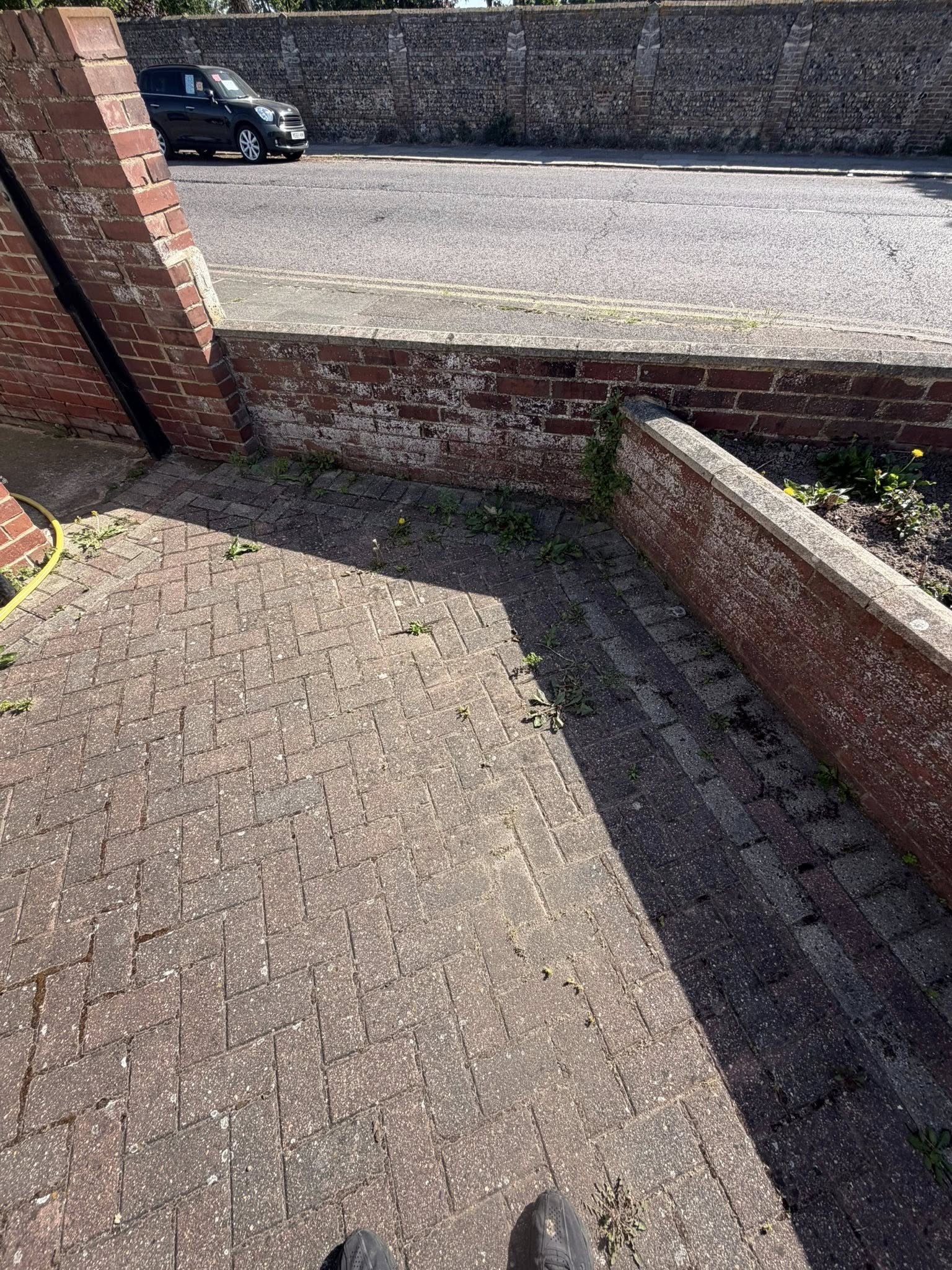 Brick wall and paved area before cleaning